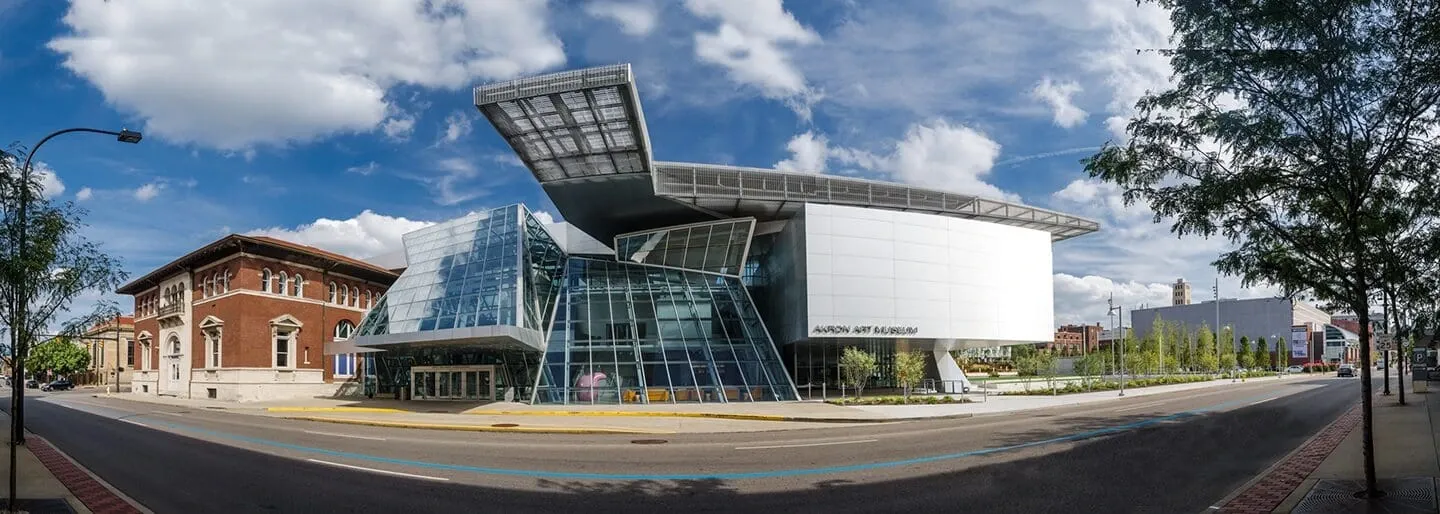 Panoramic view of the Akron Art Museum's glass and steel Roof Cloud addition beside the historic brick building in downtown Akron