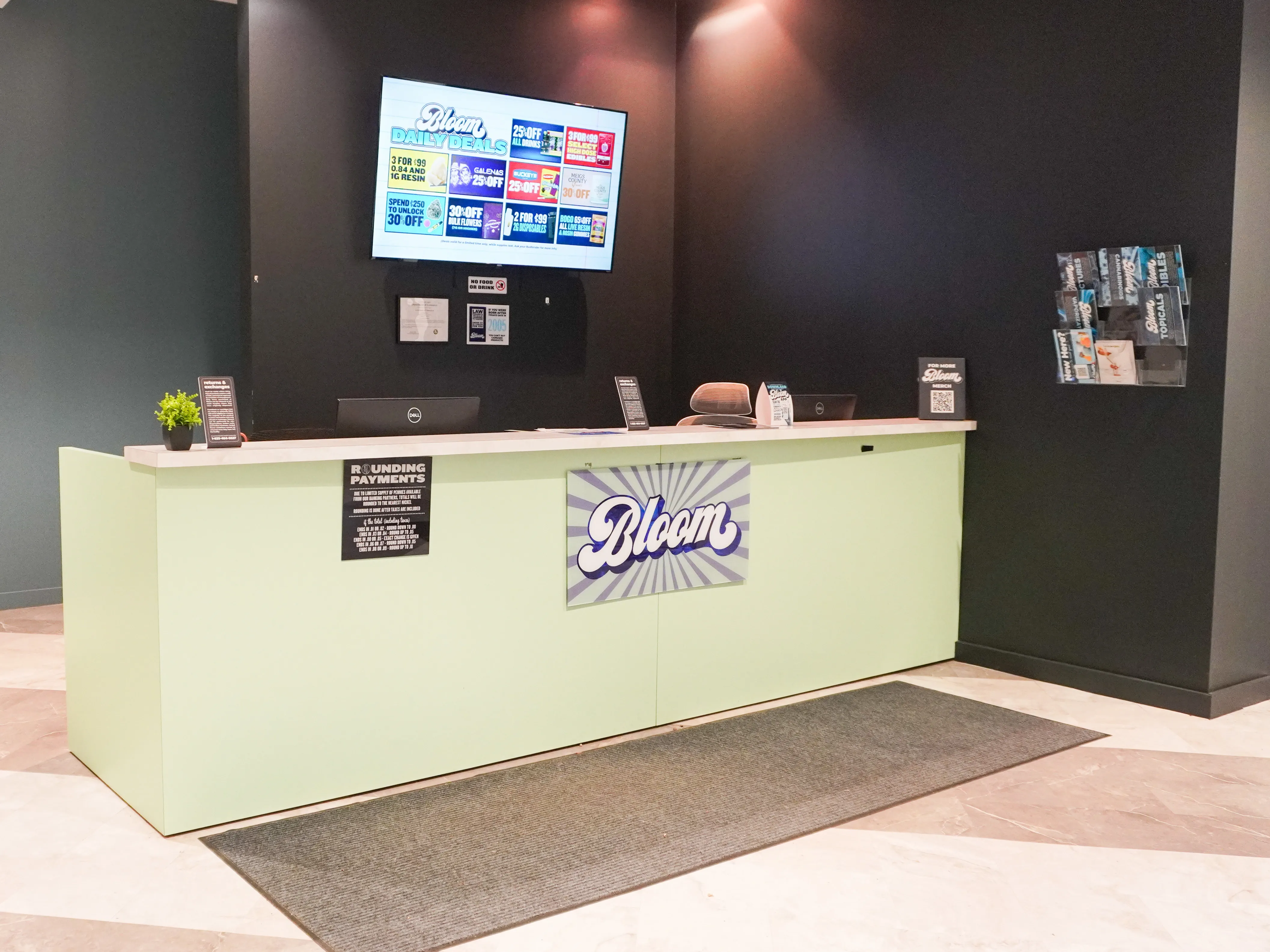 Check-in front desk with the Bloom logo and a menu screen at the Bloom dispensary in Athens, Ohio