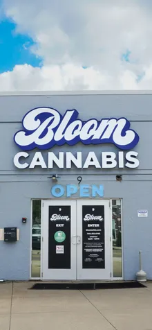 Front entrance of the Bloom Cannabis dispensary in Athens, Ohio, with double doors beneath the Bloom Cannabis sign.