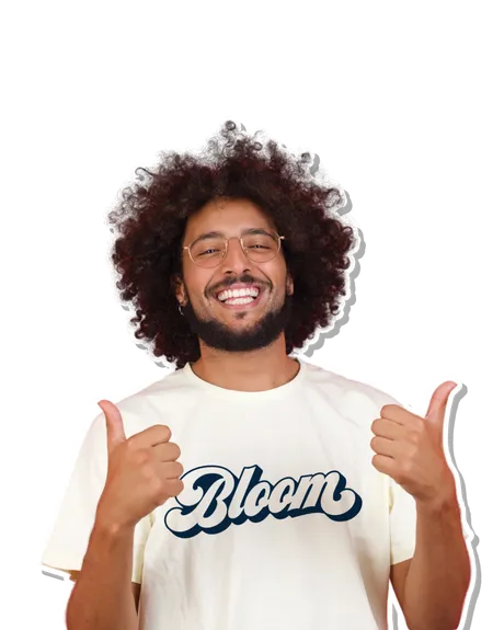 Smiling man wearing a cream Bloom Cannabis logo T-shirt and giving two thumbs up.
