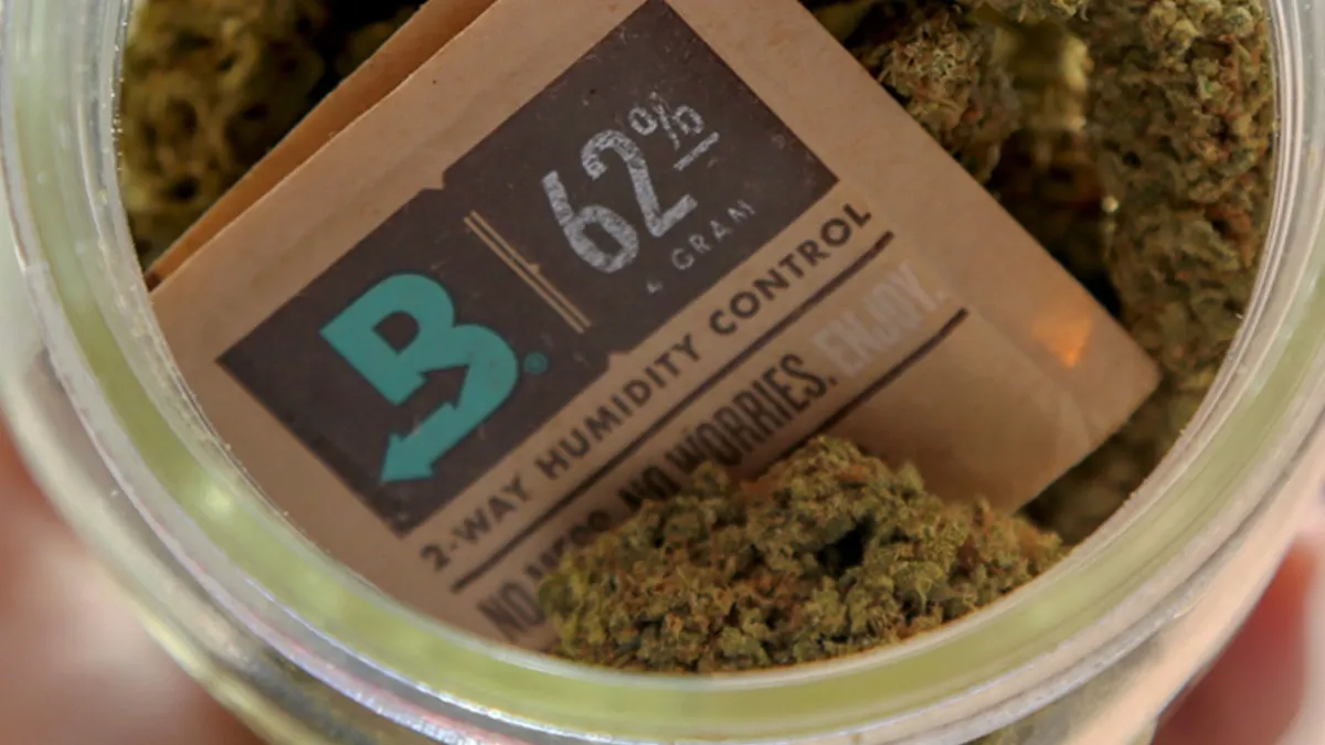Cannabis flower stored in a sealed glass jar with a Boveda 62% two-way humidity control pack