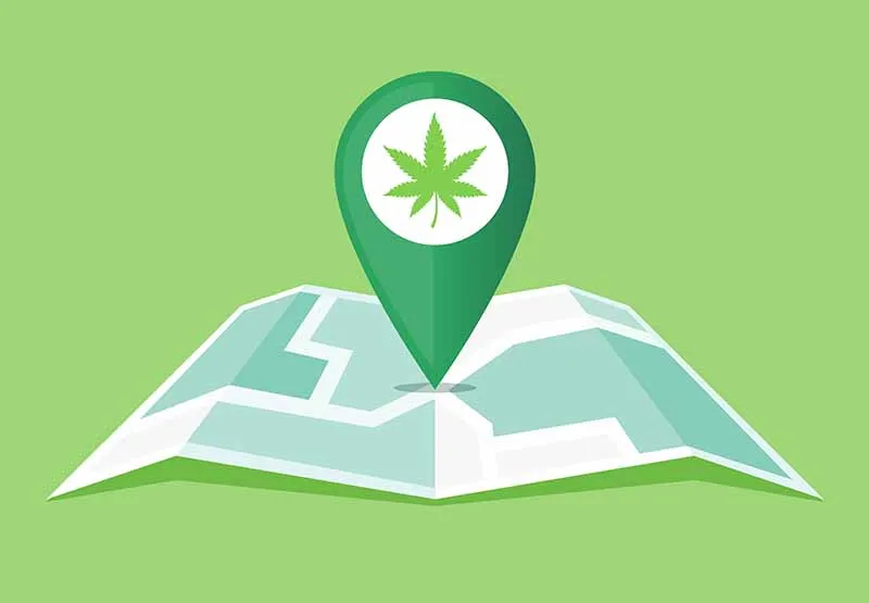 Illustrated folded map with a green location pin showing a cannabis leaf