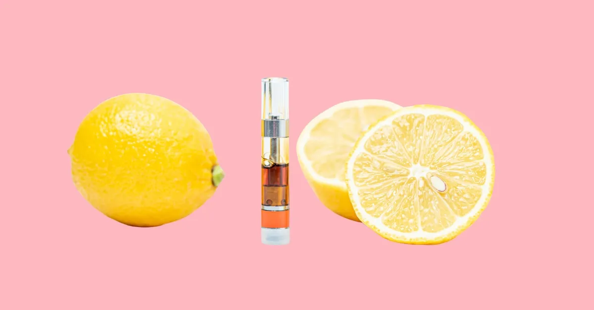 Cannabis vape cartridge between a whole lemon and two lemon halves on a pink background, representing the citrusy limonene terpene