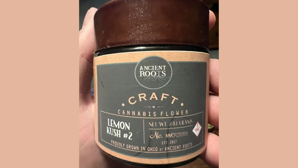 Customer holding a jar of Ancient Roots Craft Lemon cannabis flower