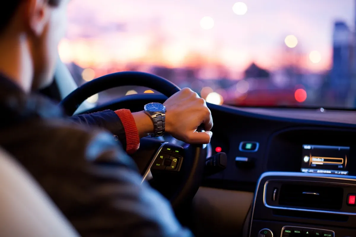 A driver with both hands on the steering wheel at dusk, illustrating Ohio's Senate Bill 56 rules for transporting cannabis in a car