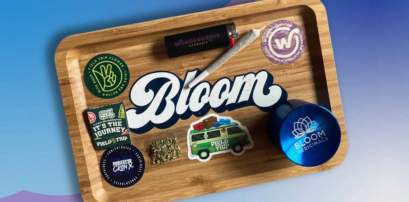 Bloom rolling tray with a grinder, pre-roll tube and Bloom stickers