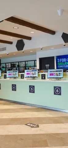 Numbered checkout counter with menu screens at the Bloom dispensary in Painesville, Ohio.